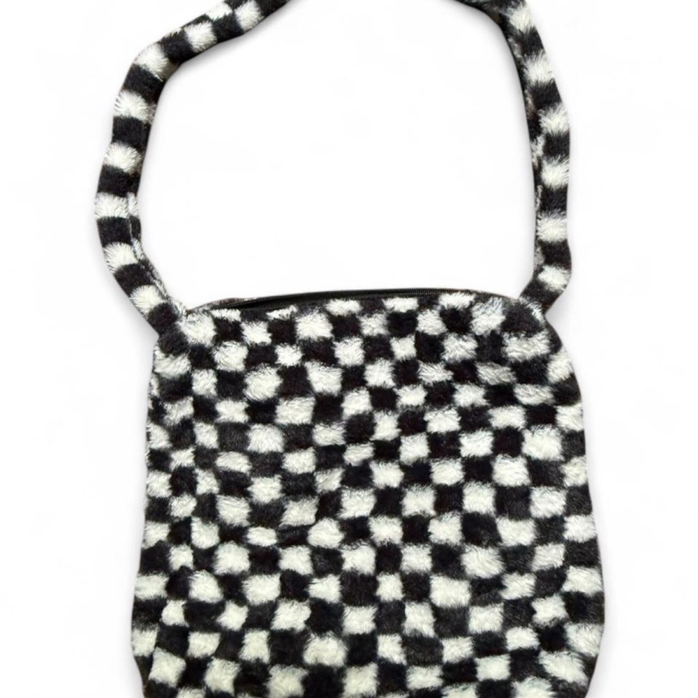 Black and white checkerboard faux fur crossbody bag. Zip top closure.